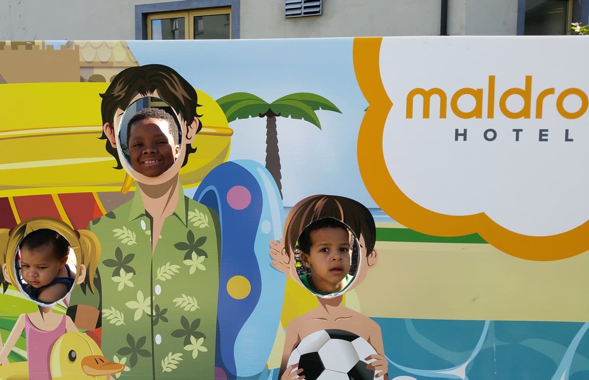 Kids smiling through a face-in-hole board at the Maldron Hotel in Galway